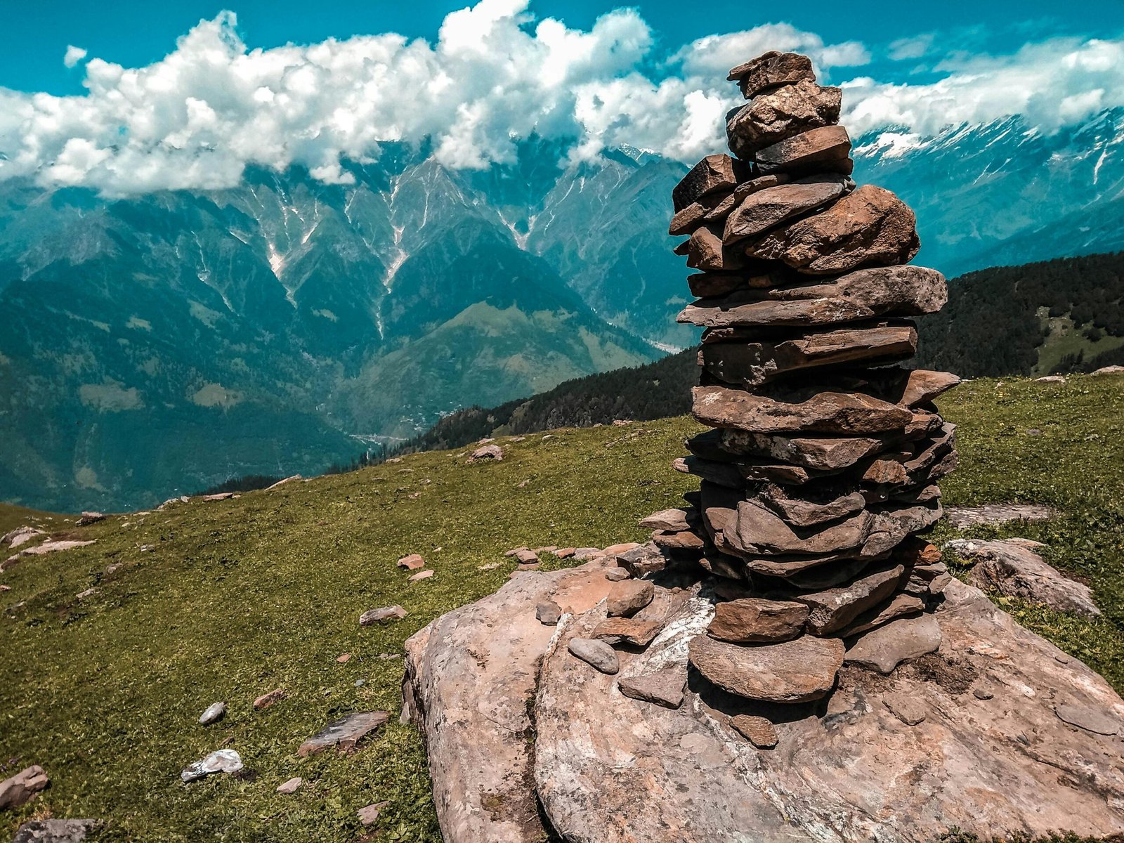 Stack of rocks with a stunning mountain landscape in the background, capturing nature's beauty and tranquility.