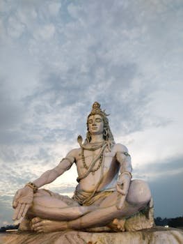 Majestic sculpture of Lord Shiva meditating in Rishikesh, India, captured during twilight.